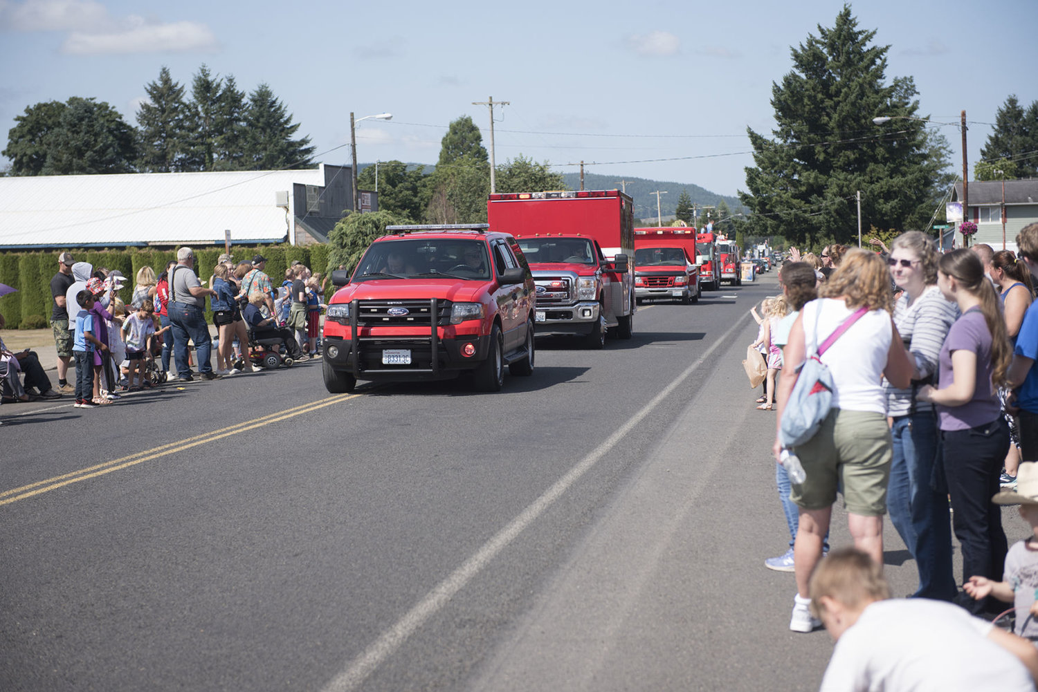 A procession of vehicle’s from the Mossyrock Fire Department take to the street during the Mossyrock Blueberry Festival parade on Saturday, Aug. 3, 2019.